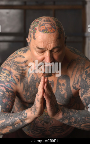 Man 50 60 with tattoos over entire body body art Stock Photo