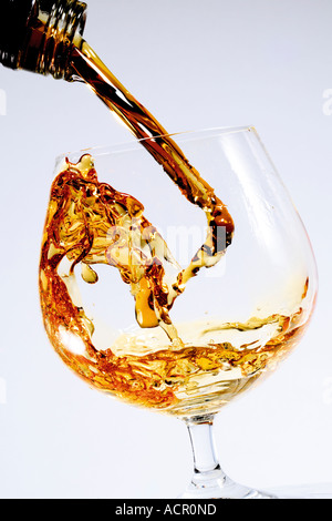 Cognac being poured into a glass Stock Photo