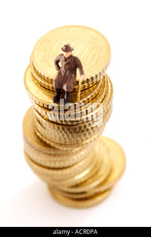 Figurine, old man, sitting on pile of coins Stock Photo