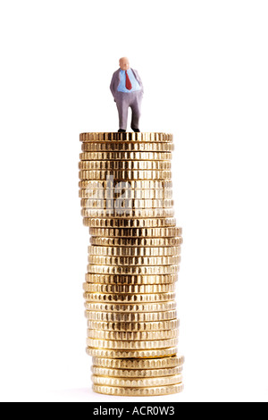 Figurine on pile of coins Stock Photo