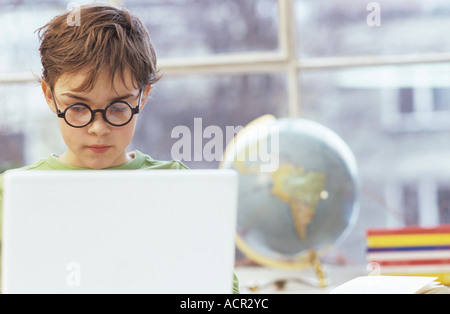 Boy (8-9) using laptop Stock Photo