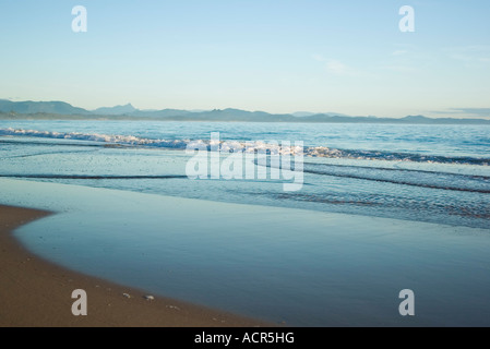 the waves are gently coming in on the tropical sandy beach Stock Photo