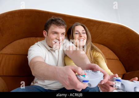 Young couple playing video game, close-up Stock Photo