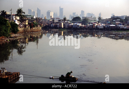 Man paddling in polluted creek 1, Manila Philippines Stock Photo