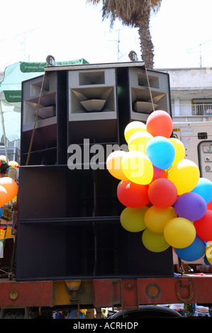 Large loud speaker decorated with balloons on a float during a festive parade Stock Photo