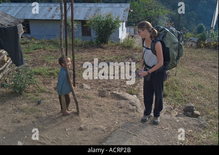 Wende Valentine chats with a Lepcha boy near Yuksom during a trek to Kecheopalri Lake through lower Sikkim India Stock Photo