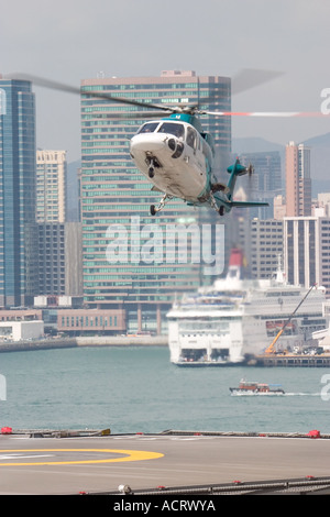 HeliJet Express helicopter lands or take off at heliport shun tak centre hong kong island returning from Macau Hong Kong HKSAR Stock Photo