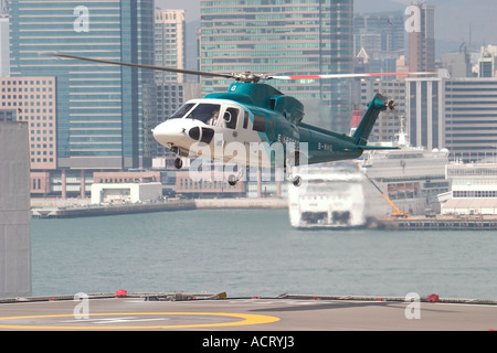 HeliJet Express helicopter lands or take off at heliport shun tak centre hong kong island returning from Macau Hong Kong HKSAR Stock Photo