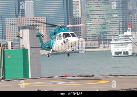 HeliJet Express helicopter lands or take off at heliport shun tak centre hong kong island returning from Macau Hong Kong HKSAR Stock Photo