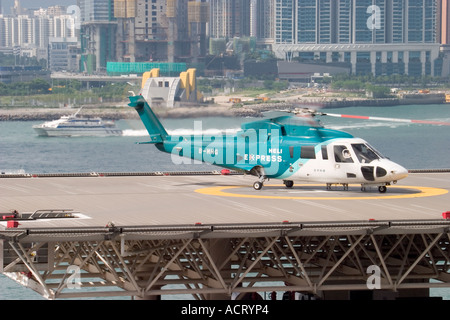 HeliJet Express helicopter lands or take off at heliport shun tak centre hong kong island returning from Macau Hong Kong HKSAR Stock Photo