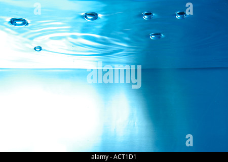 water surface seen from underwater with bubbles Stock Photo