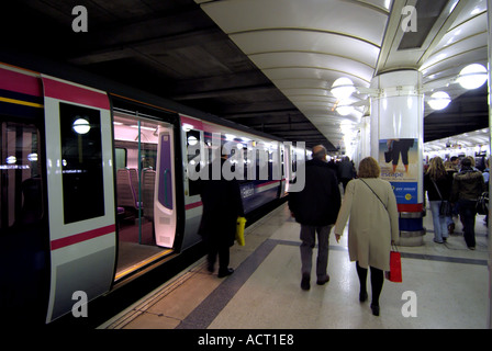 Liverpool Street railway station platform First Great Eastern train just arrived  back view of morning commuters walking to the exit London England UK Stock Photo