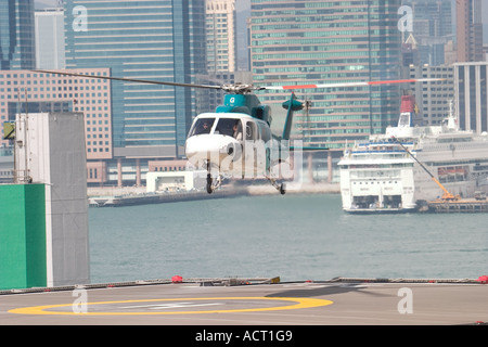 HeliJet Express helicopter lands or take off at heliport shun tak centre hong kong island returning from Macau Hong Kong HKSAR Stock Photo