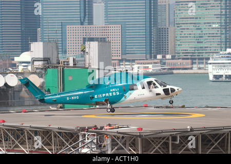 HeliJet Express helicopter lands or take off at heliport shun tak centre hong kong island returning from Macau Hong Kong HKSAR Stock Photo