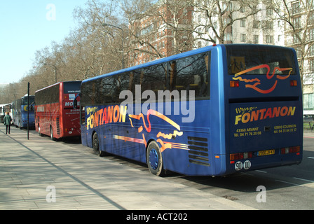 Park Lane Hyde Park long line of continental tourist coaches parked awaiting return of passengers Stock Photo