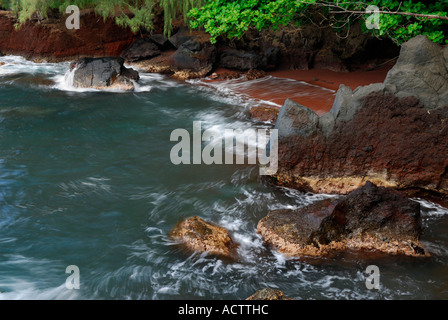 Red sand pocket beach at Kauiki Hill in Hana Maui Hawaii Stock Photo