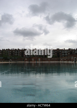 Refurbished poolside of the Hampstead Lido which is overlooked by a terrace of houses London UK Stock Photo