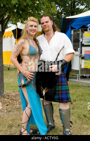 Beautiful couple dressed in old European dress standing in pride. Stock Photo