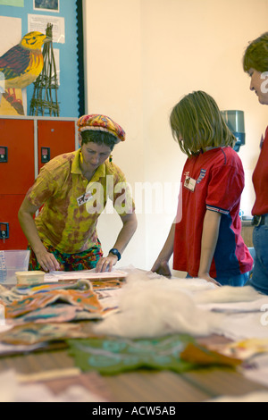 teacher showing students how to work with felt Stock Photo