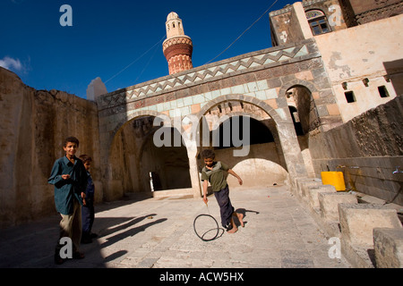 Children playing in the courtyard of Queen Arwa Mosque Jibla Yemen Stock Photo