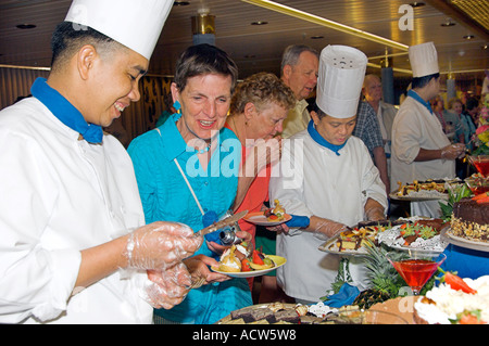 Chefs serving desserts at the Desert Extravaganza on the Holland America cruise ship Zaandam Stock Photo