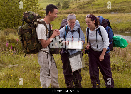three young people two girls and one boy on hiking trip through remote rural mid wales between Tregaron and Llandovery, spring Stock Photo
