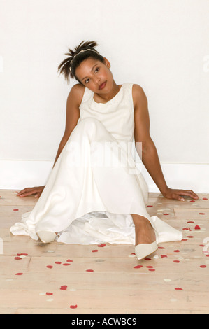 Bride sitting on wooden floor Stock Photo