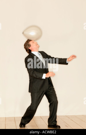 Man balancing a balloon on head Stock Photo