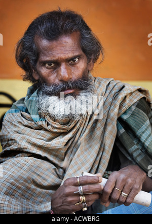 Bearded man in stare with scroll Varanasi Benares India Stock Photo
