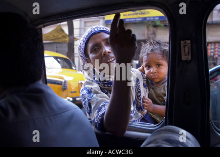 A street beggar gets into the car Calcutta Kolkata India Stock Photo