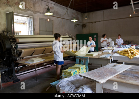 Antique Hotel Laundry Shop Sheet ironing and folding Stock Photo