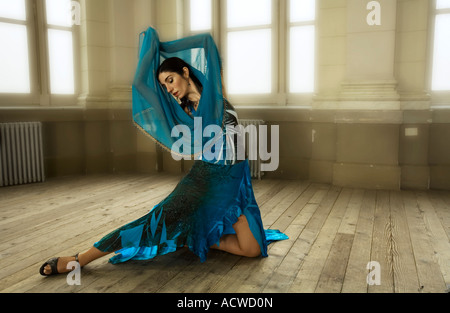 A woman dancer in a Blue dress in an old fashion dance hall Stock Photo