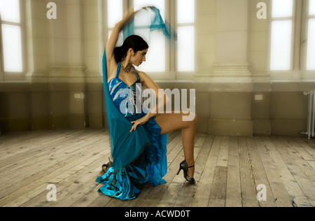 A woman dancer in a Blue dress in an old fashion dance hall Stock Photo