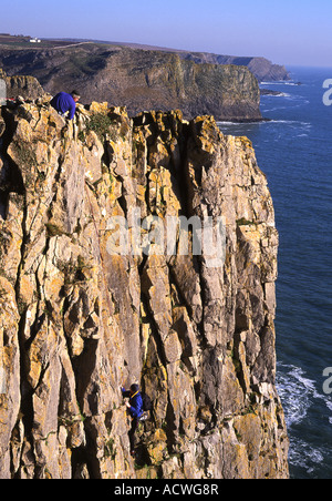 Rock climbing on sea cliffs at Fall Bay near Rhossili Gower Peninsula Swansea South Wales UK Stock Photo
