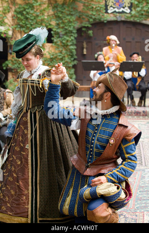 A COUPLE DRESSED IN MEDIEVAL DRESS IS DANCING ON A DANCING FLOOR Stock Photo