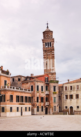 leaning church bell tower Campanile of Chiesa di Santo Stefano in Venice Italy as seen from deserted Campo San Angelo Stock Photo