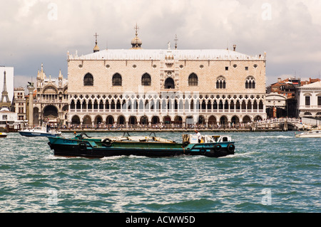 Doges Palace in Sestieri Marco in Venice Italy seen from Canale Della Giudecca with boat traffic in foreground Stock Photo