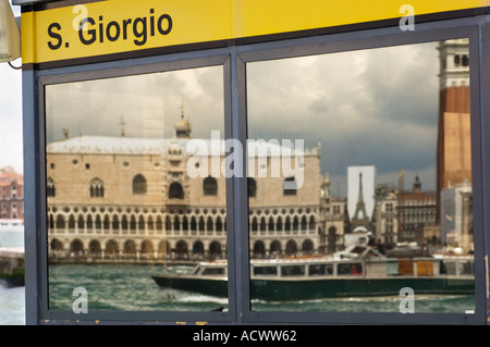 Doges Palace and the Campanile San Marcos in Venice reflected in the window of the San Giorgia Vaporetto water bus stop Stock Photo