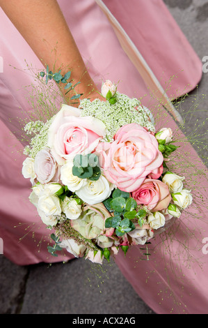 bridesmaid holding boquet at wedding Stock Photo