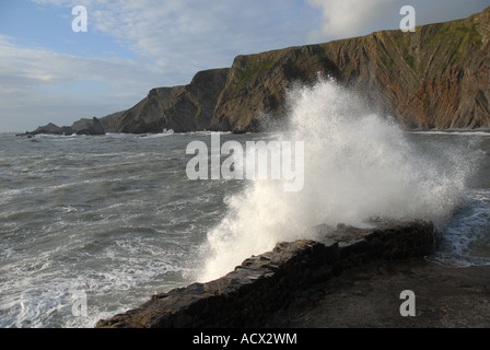 Waves crash onto the wall at Hartland Quay, North Devon, UK Stock Photo