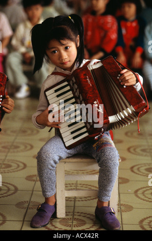 Young girl playing accordion China Stock Photo