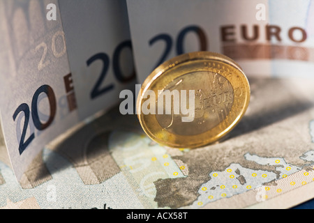 Euro sitting on euro bank notes Stock Photo