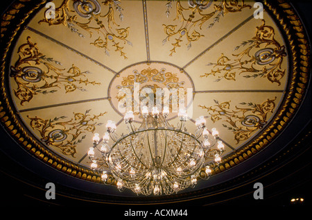 Close up of chandelier and decorated ceiling in the auditorium interior of The Old Vic Theatre London Stock Photo