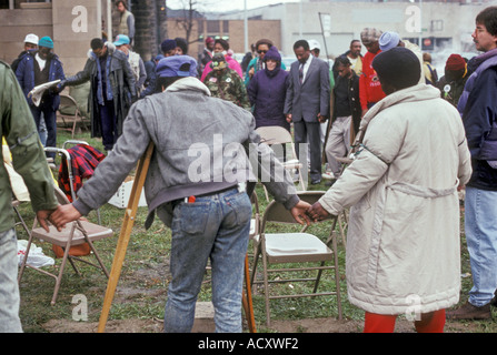 Homeless People and Supporters Join Hands in Prayer Stock Photo