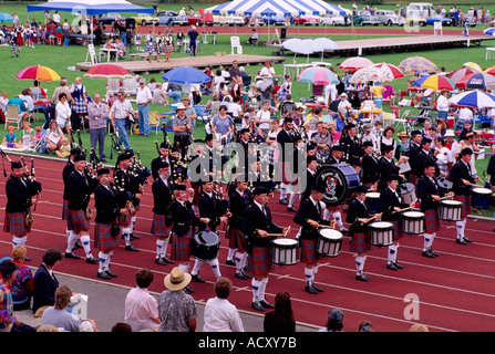 A Marching Pipe Band playing Bagpipes and Drums at the Scottish Highland Games Celebration in Coquitlam British Columbia Canada Stock Photo