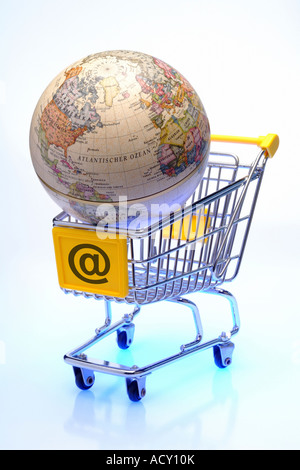 An empty shopping cart with @ on it and a globe in it Stock Photo
