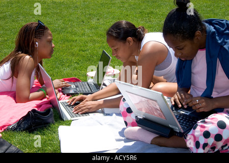 African american female students study using laptop computers on the lawn of Albion College in Michigan. Stock Photo