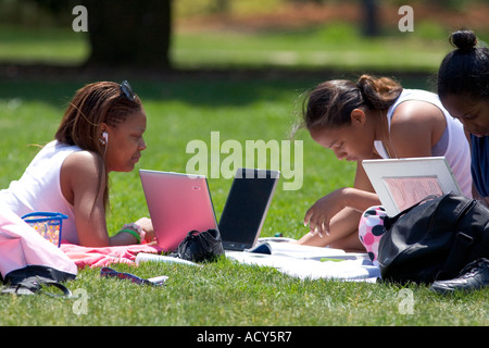 African american female students study using laptop computers on the lawn of Albion College in Michigan. Stock Photo
