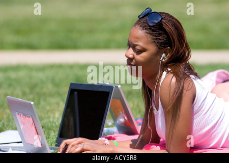 African american female students study using laptop computers on the lawn of Albion College in Michigan. Stock Photo