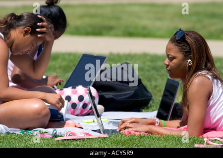 African american female students study using laptop computers on the lawn of Albion College in Michigan. Stock Photo